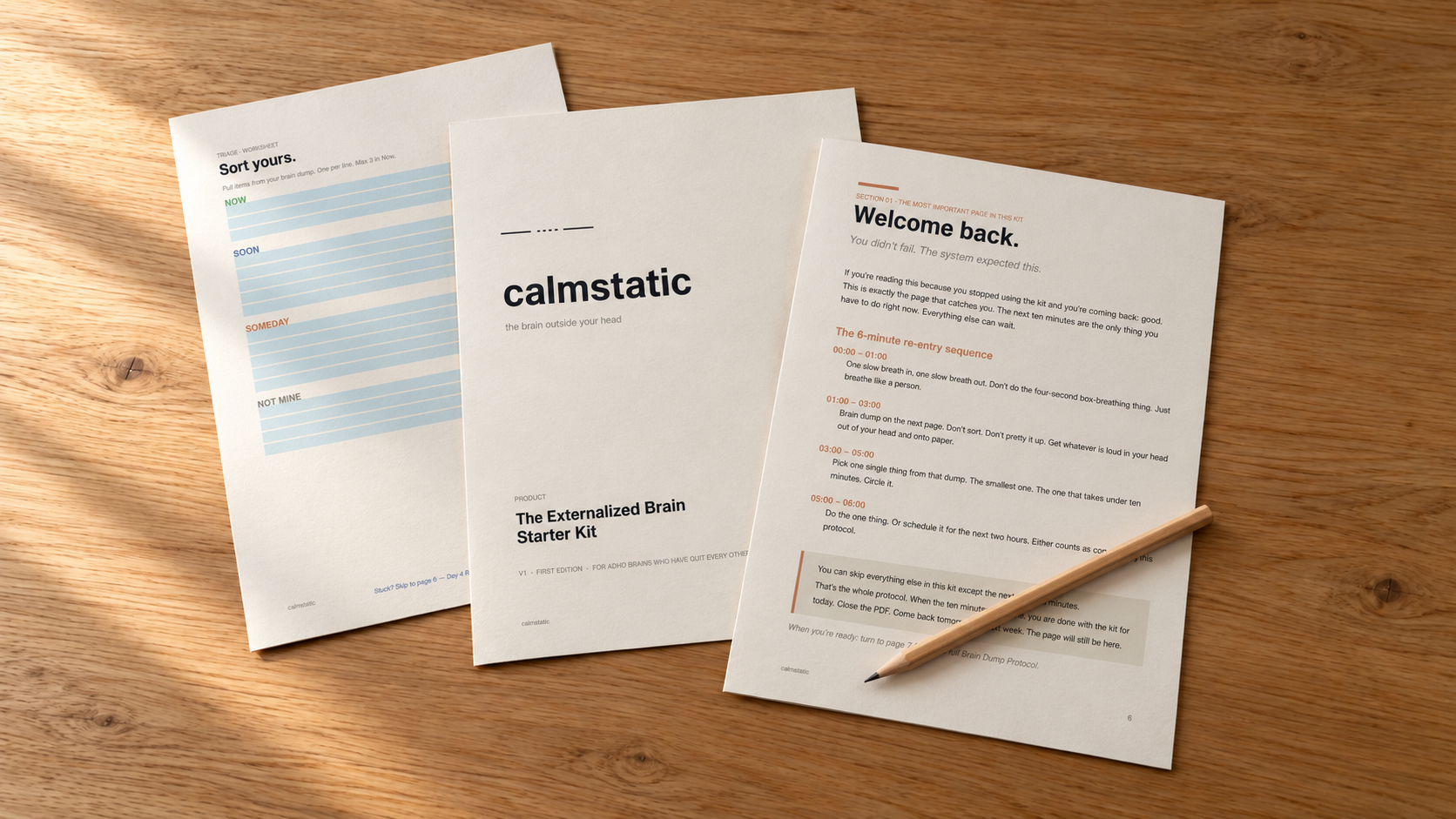 The Calmstatic Starter Kit pages laid out on a wooden desk with a pencil.
